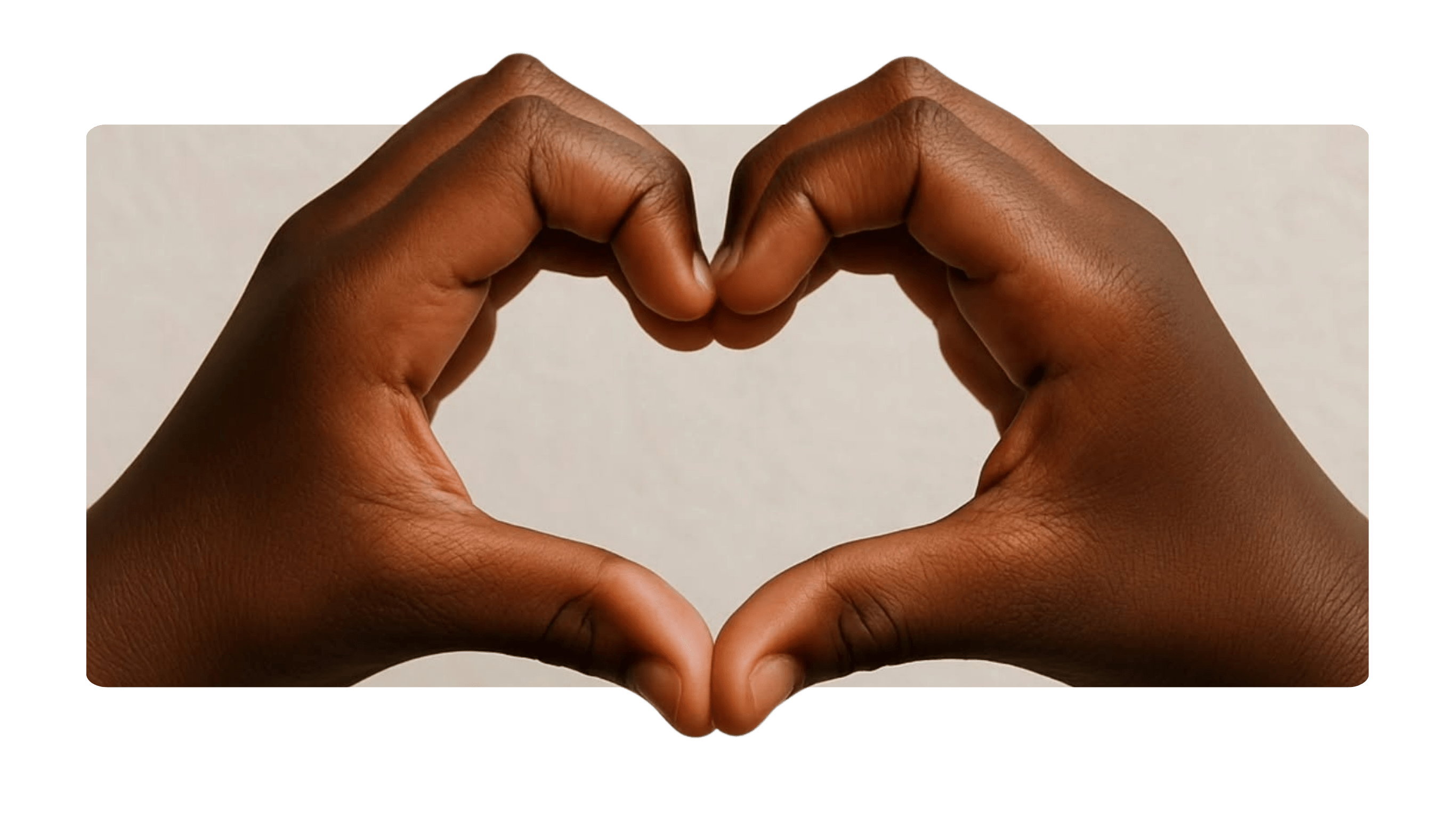 Two pairs of hands forming a heart shape