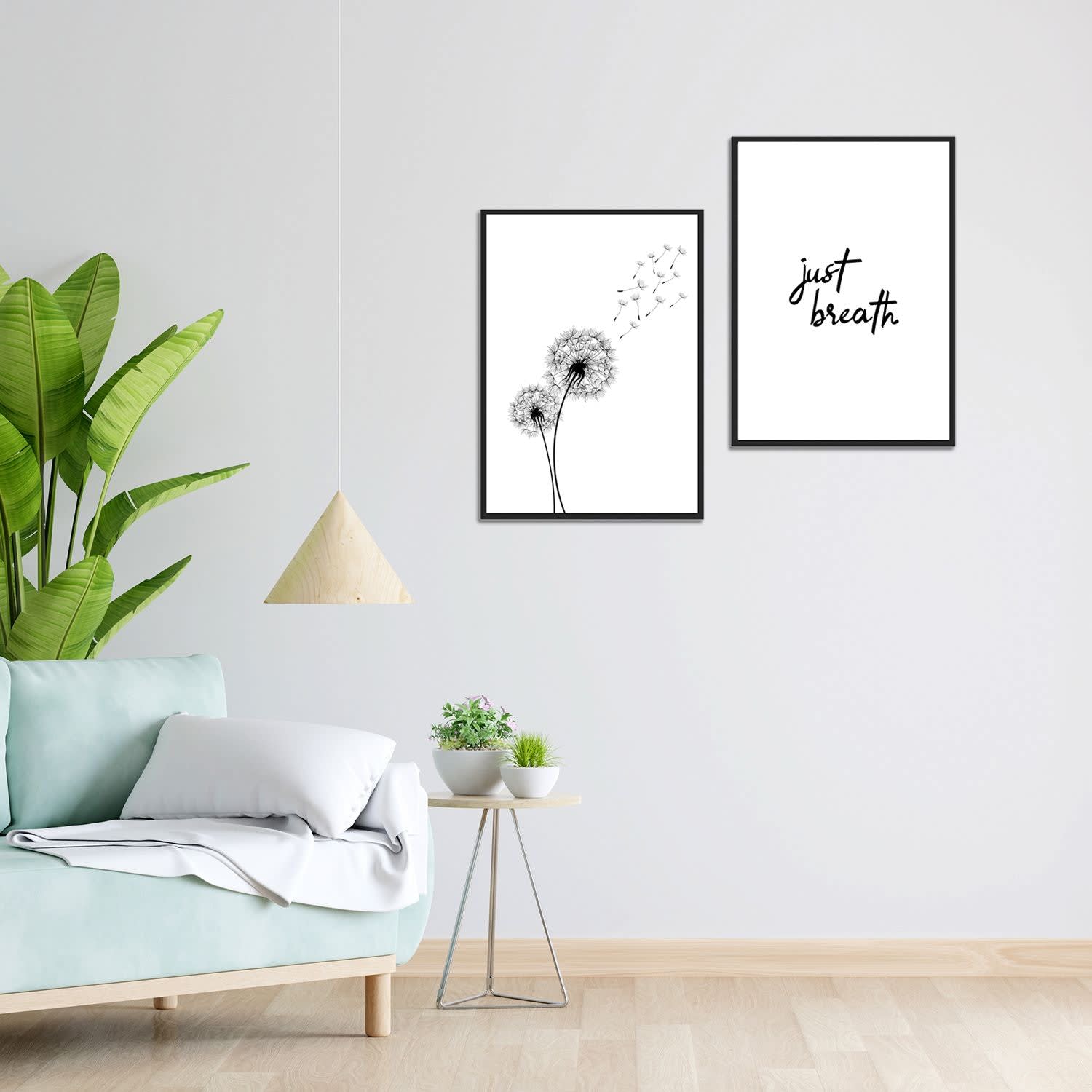 Pair of framed wall art prints hanging side by side above a bedside table