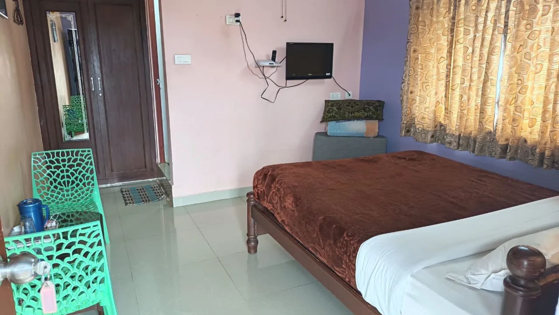 Bedroom setup at ADK Royal Park Inn near Ooty town