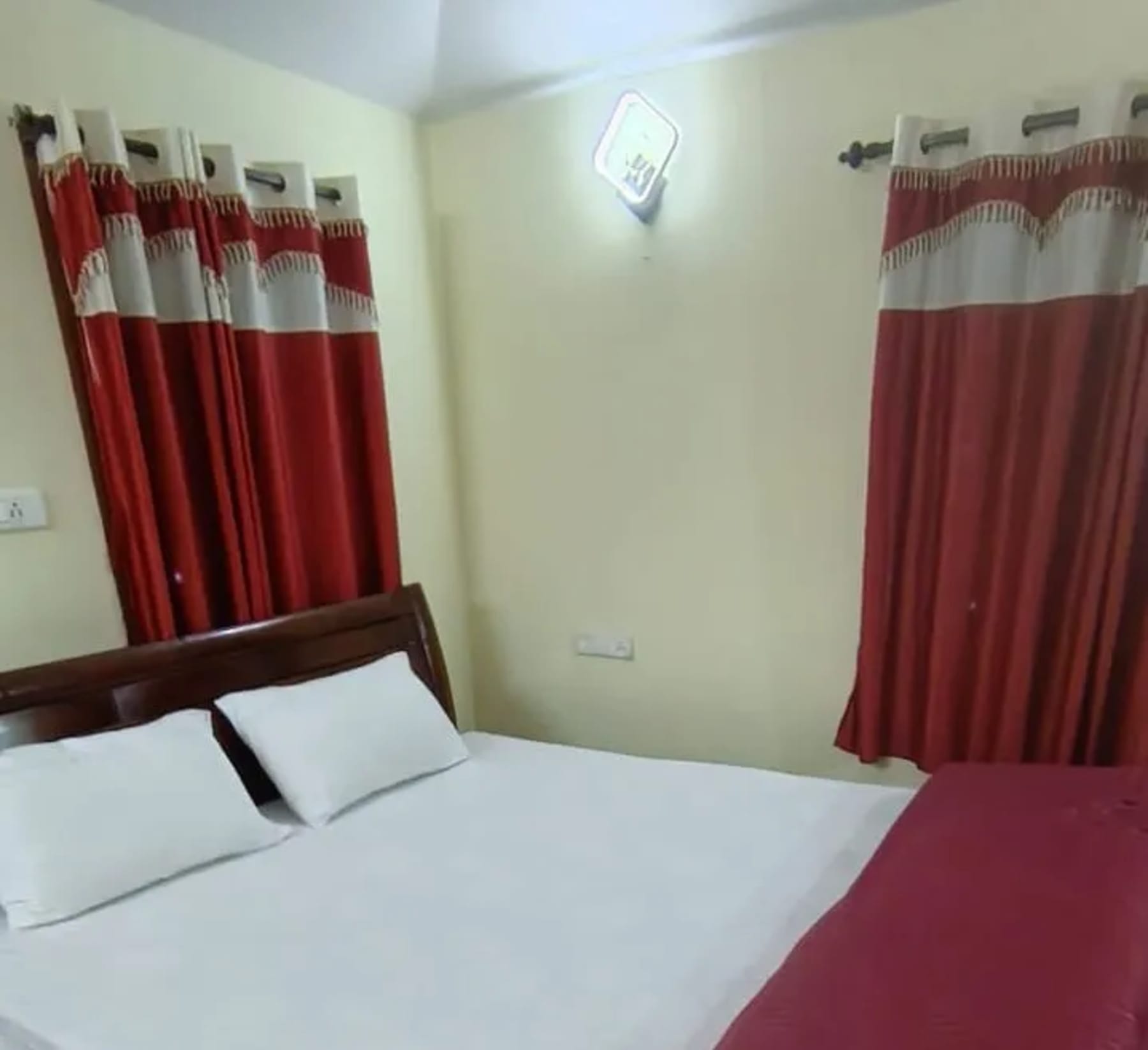 Clean bedroom at ADK Royal Park Inn 2 in Ooty