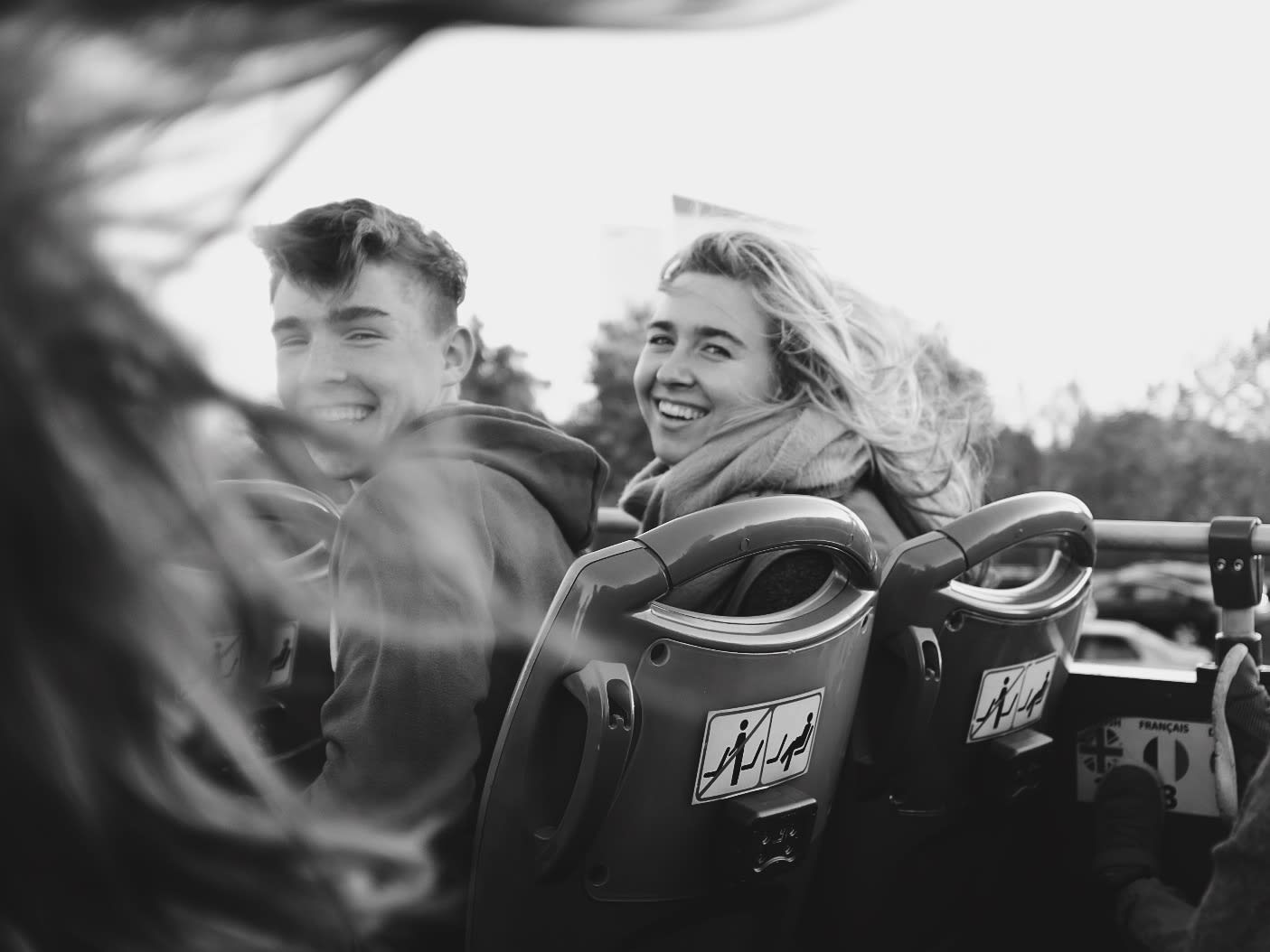 Two teens laughing together on a ride
