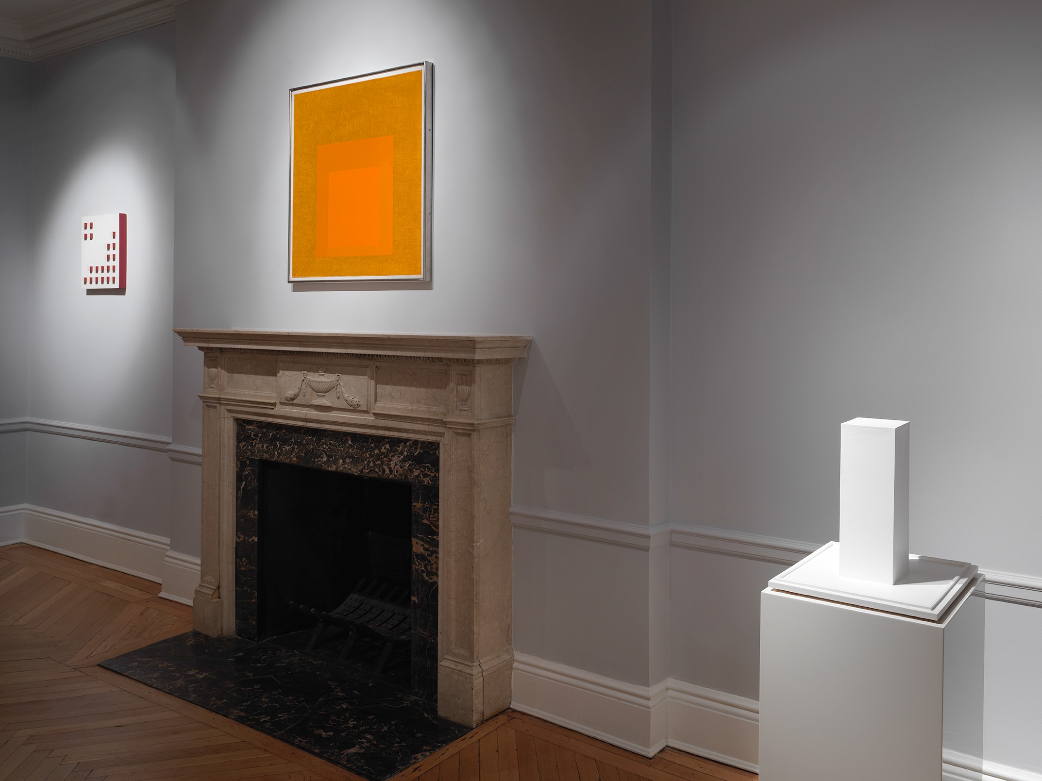 Installation view with Lygia Pape's Relevo on the left wall, Josef Albers's Homage to the Square: Golden above the mantel, and Sol LeWitt's Untitled (B3 Model) at right.