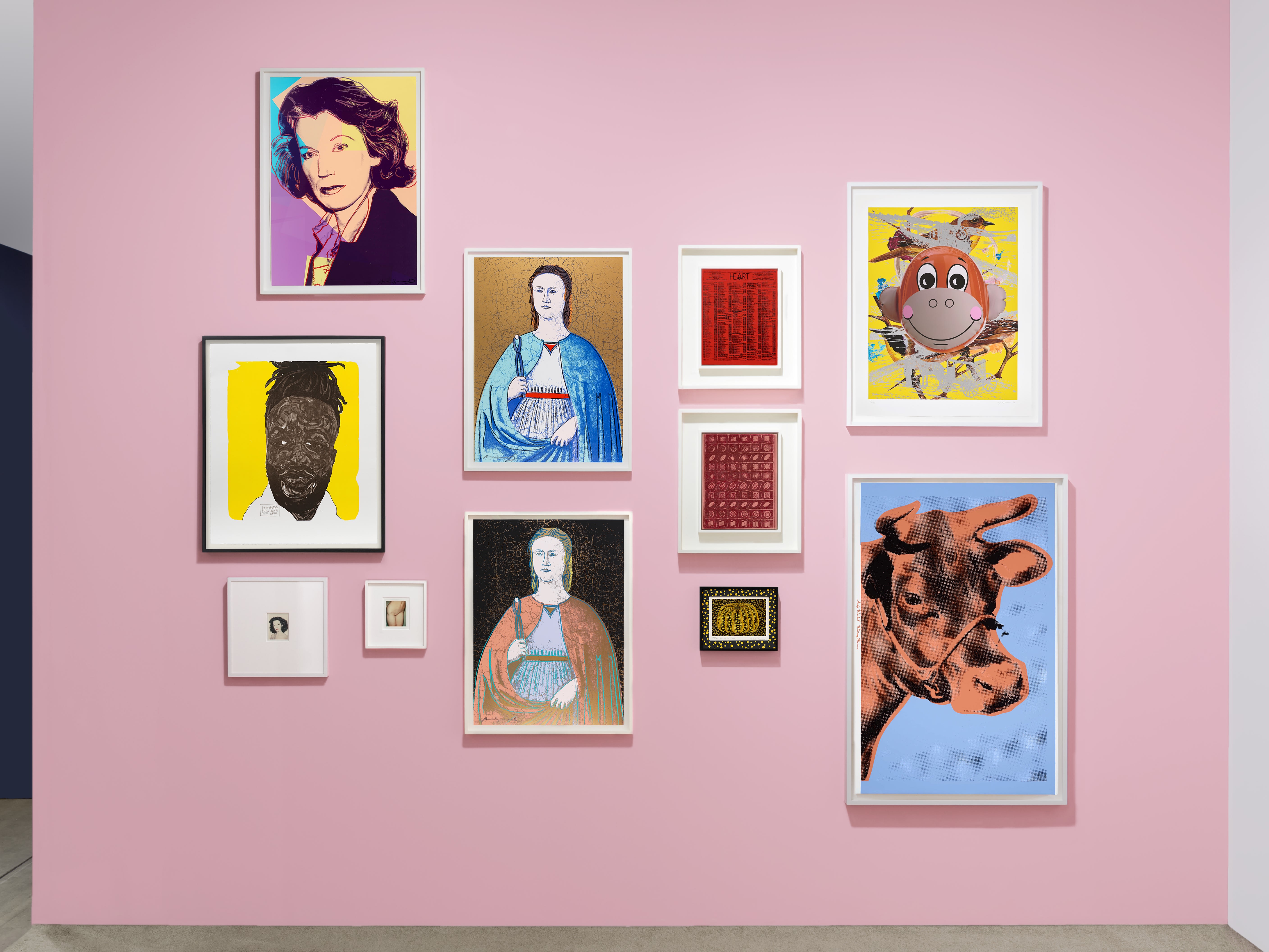 Installation view at Art Miami 2023 in Miami, with framed works clustered across a solid pink booth wall.