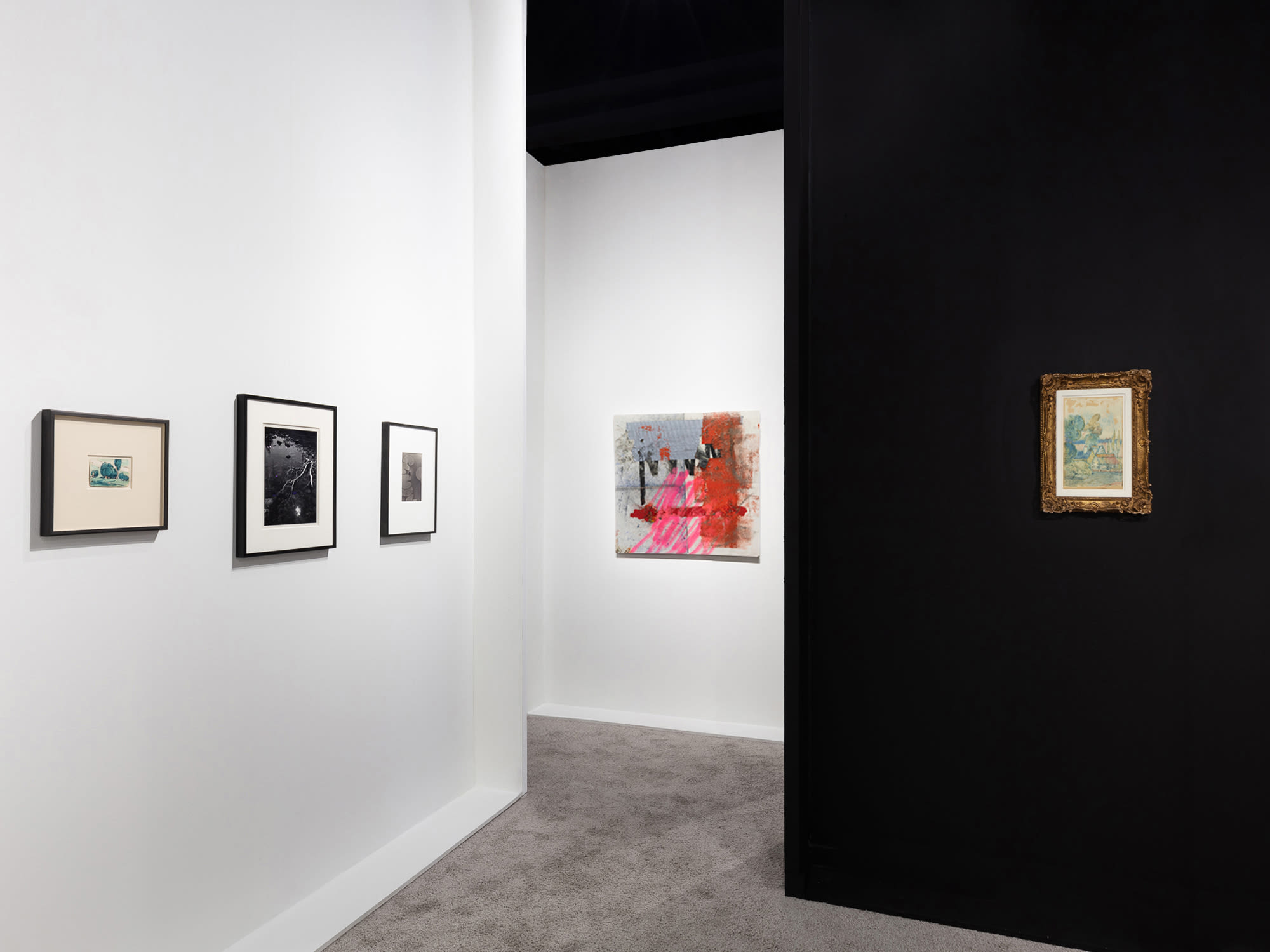 Installation view at Palm Beach Modern + Contemporary 2022 in West Palm Beach, with framed works visible around a black partition dividing the view.