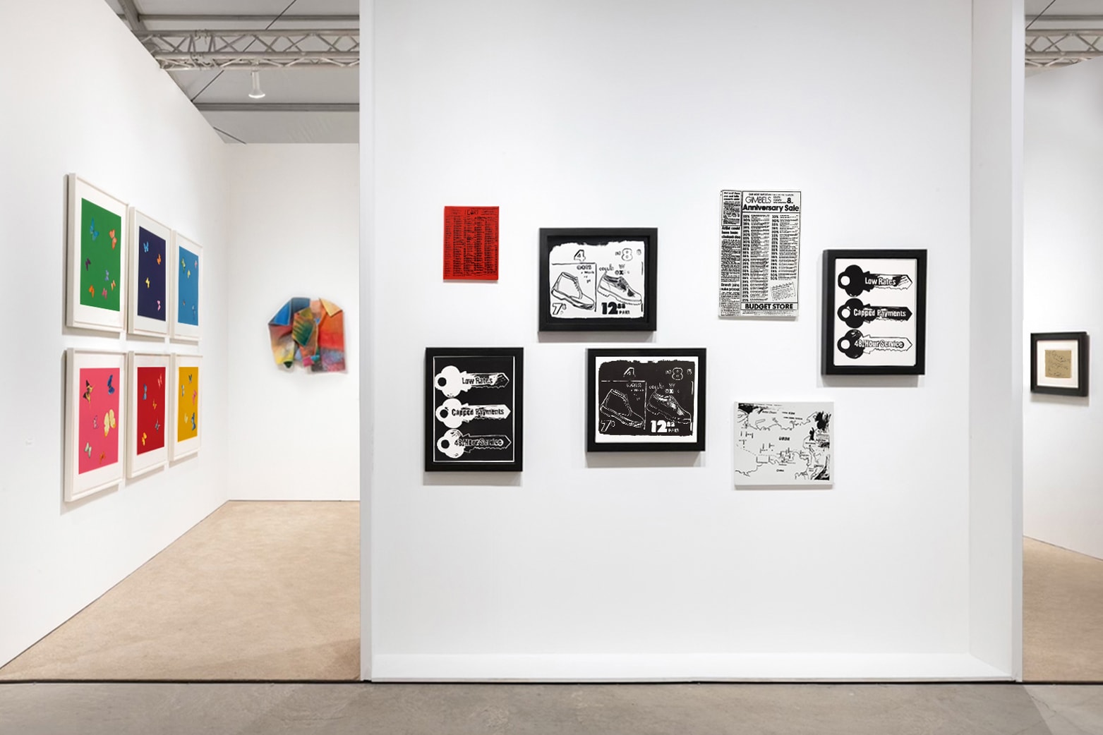 Installation view at Art Miami 2021 in Miami, with framed works on white walls visible through an open partition into an adjacent space.
