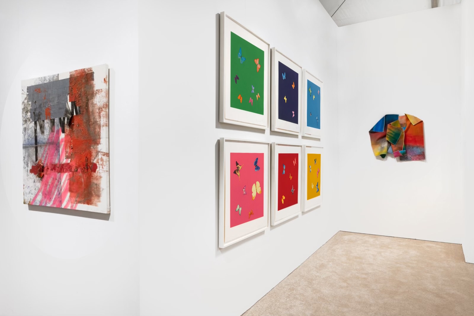 Installation view at Art Miami 2021 in Miami, with framed works across multiple walls in a wider corner view, including a three-dimensional work on the far wall.