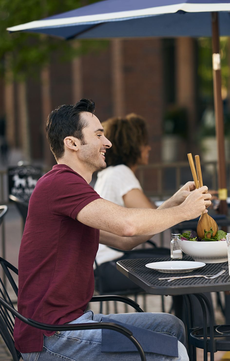 Woman and man sit down at restaurant to eat