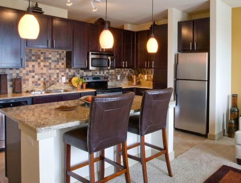 Kitchen and living room at Post Sierra luxury apartment homes in Dallas, TX