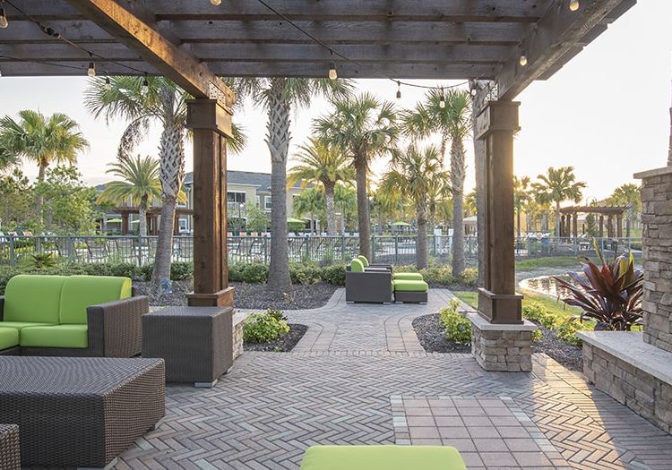 Seating by Pond at Colonial Grand Apartments at Hampton Preserve luxury apartment homes in Tampa, FL