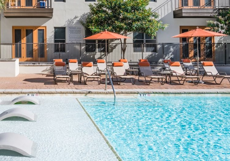 Pool tanning shelf at Post Katy Trail luxury apartment homes in Dallas, TX