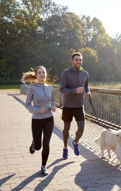 Woman and Man run with dog