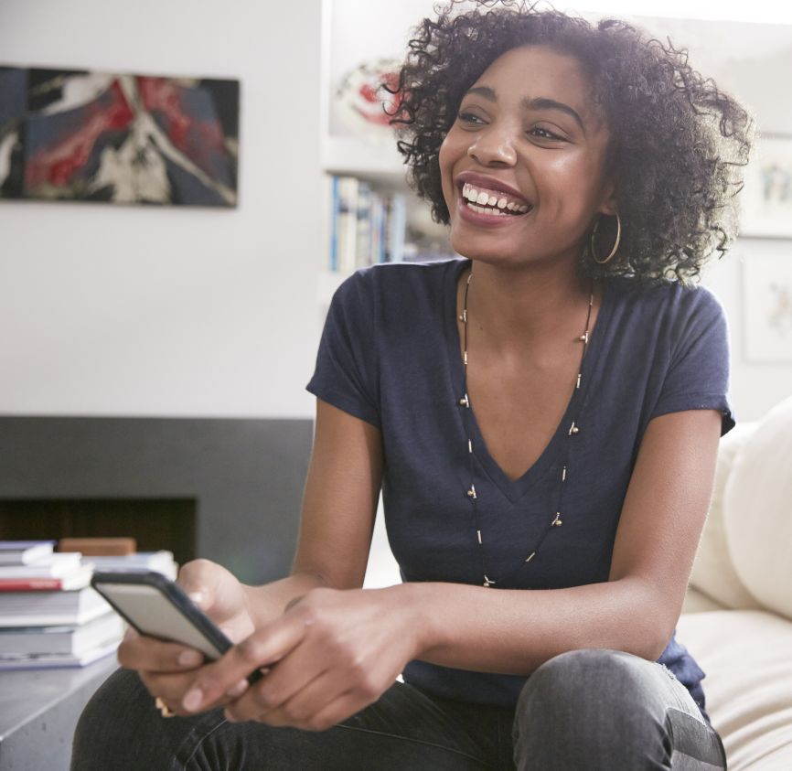 Woman in her home smiling on the couch