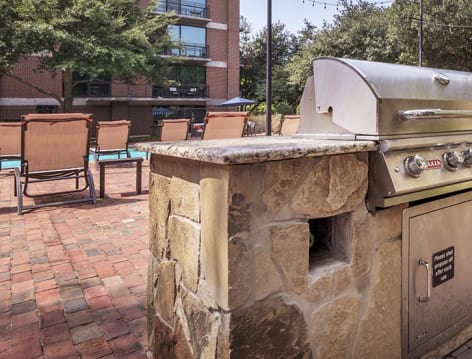 Outdoor grill area at Post Gallery luxury apartment homes in Dallas, TX