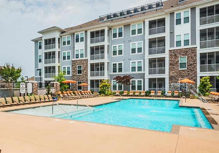 Pool and building exterior at Stonefield Commons luxury apartments in Charlottesville, VA