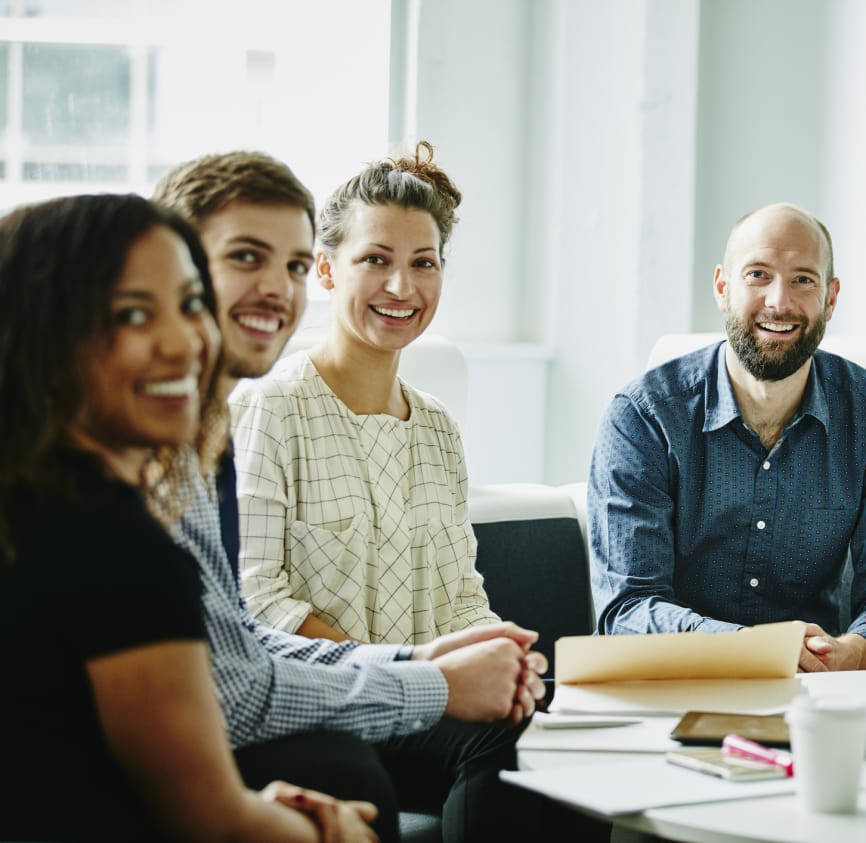 People in an office smiling