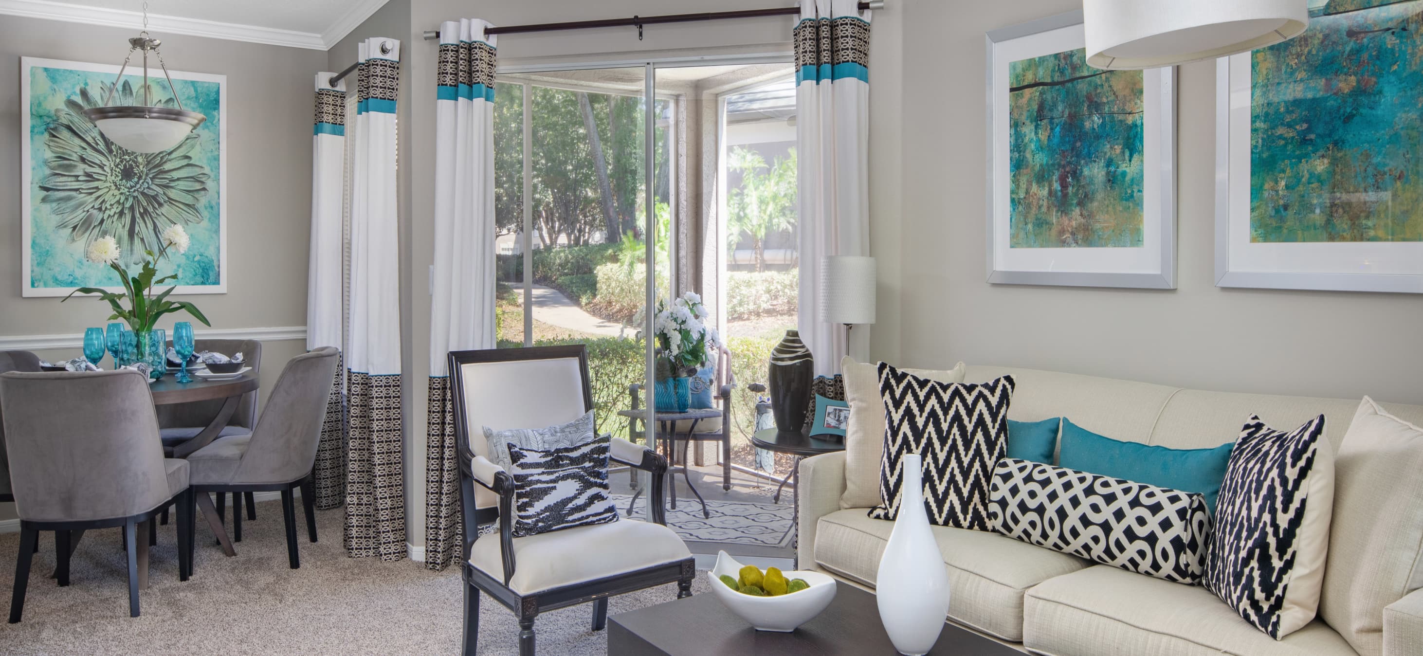 Modern-style living room with sliding doors to patio at MAA Heathrow luxury apartments in Orlando, FL