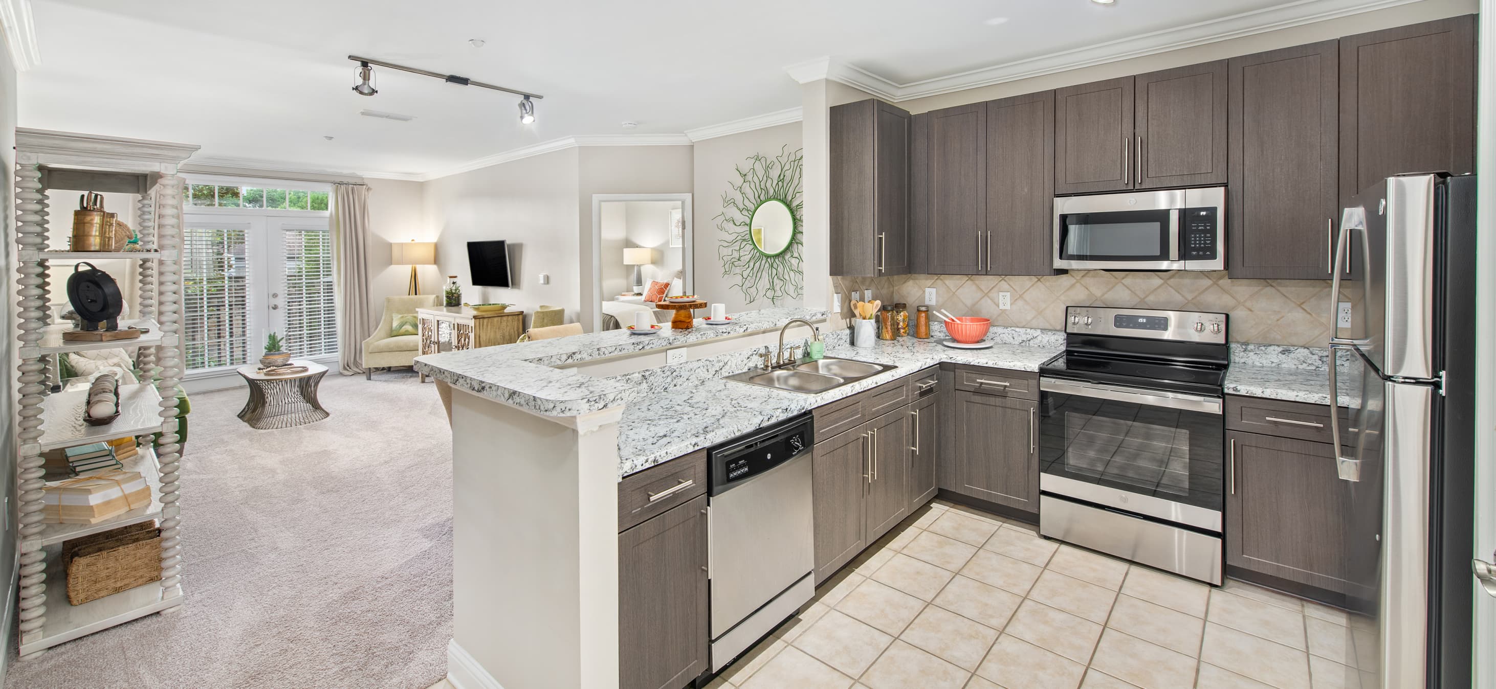 Model home view of kitchen and open living room space at MAA West Village luxury apartments in Smyrna, GA