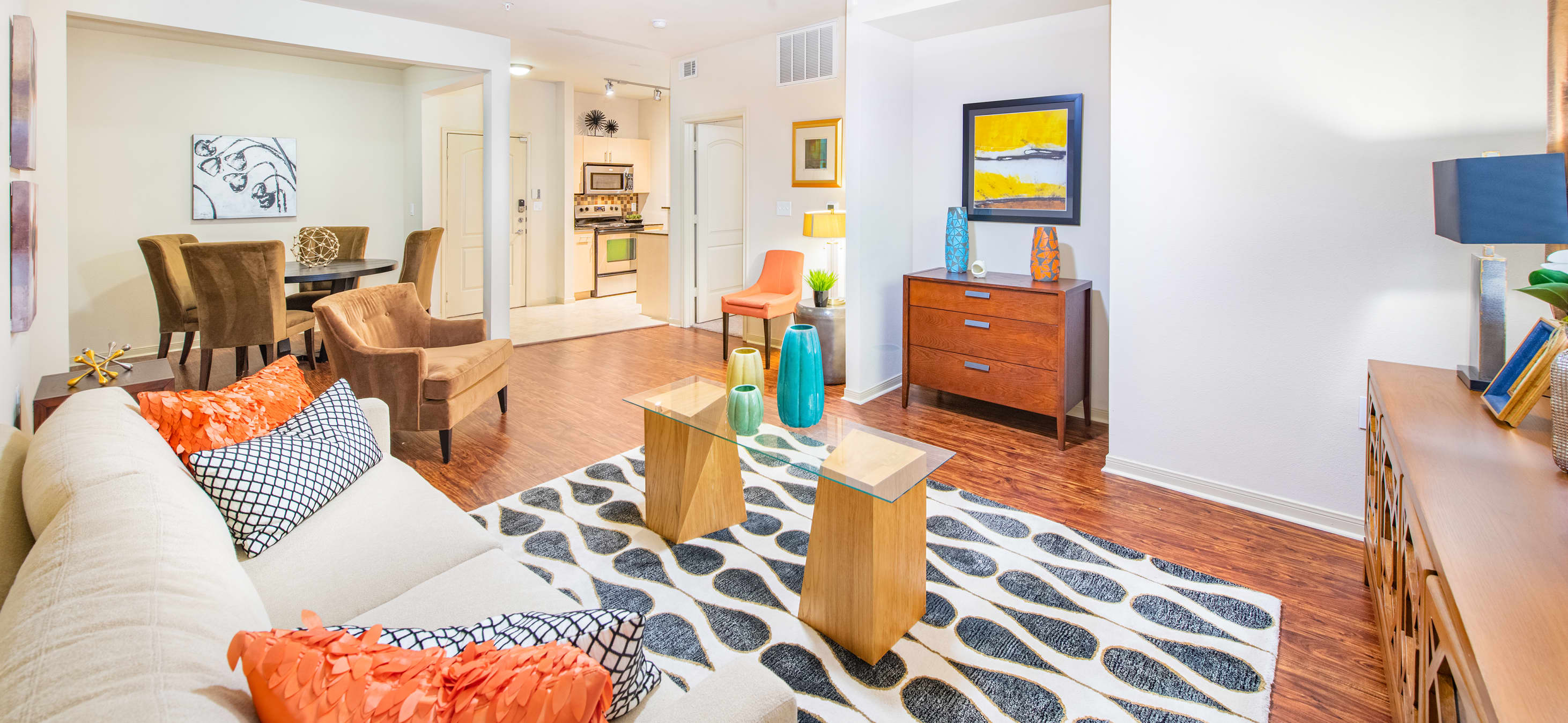Modern-style rustic living room with hardwood floors in an open floorplan at MAA Heights luxury apartments in Dallas, TX
