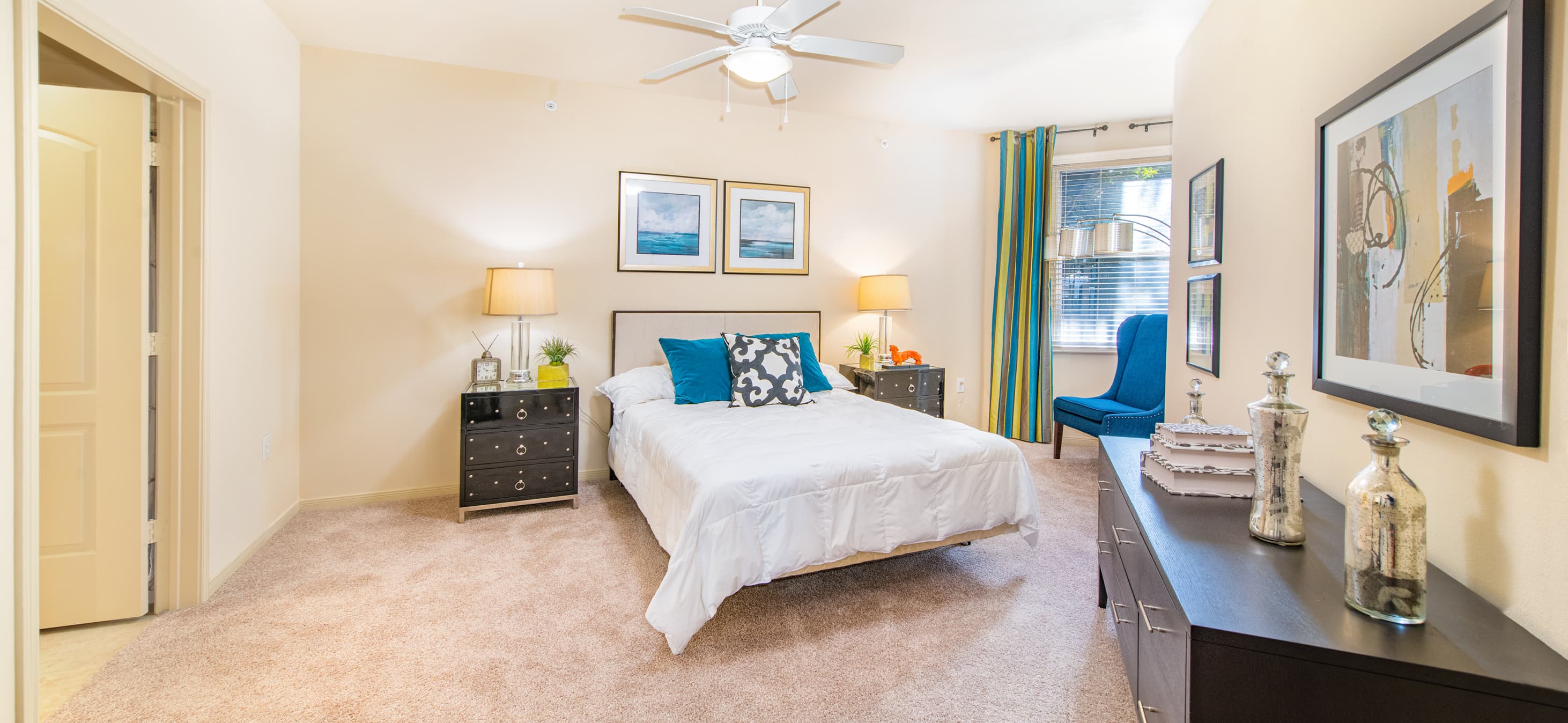 Spacious and cozy bedroom with a reading nook and modern furniture at MAA Heights luxury apartments in Dallas, TX