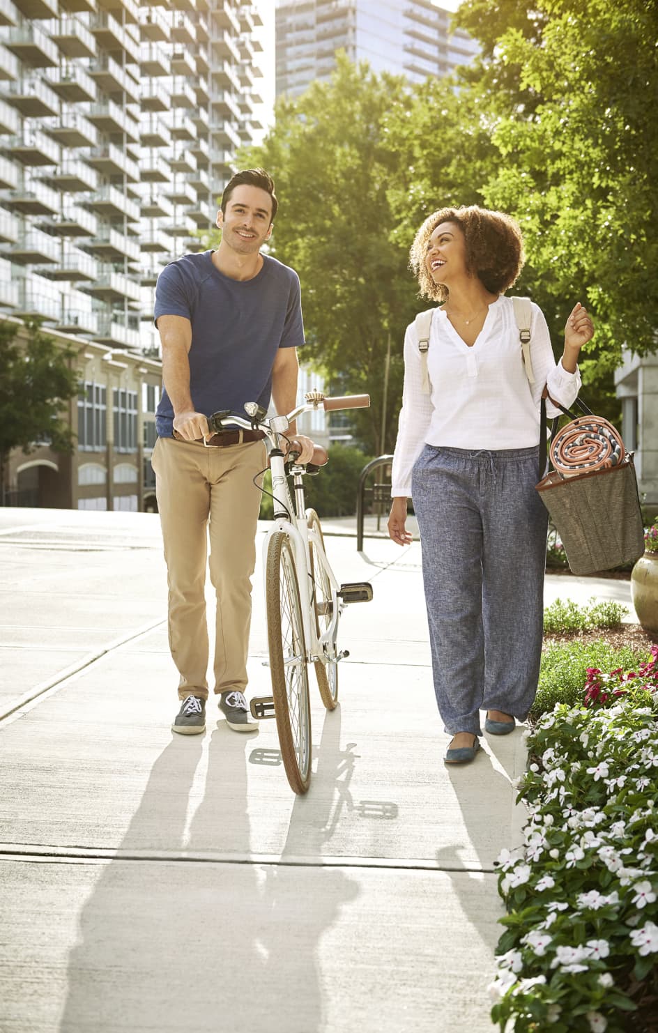 Man with bike walks with woman smiling