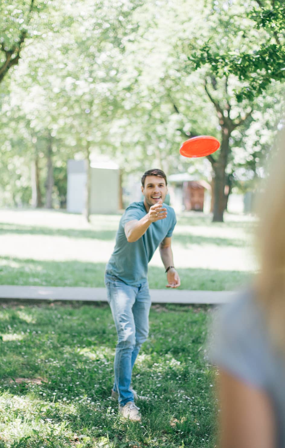 Tossing a frisbee in a park