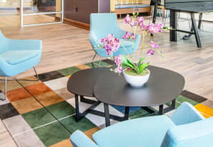 Clubhouse coffee table with turquoise chairs at MAA Centennial Park luxury apartments in Atlanta, GA