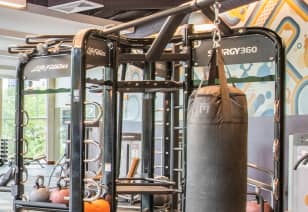 Fitness center with free weights and weight bag at MAA Centennial Park luxury apartments in Atlanta, GA