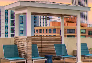 Poolside cabana lounge areas at MAA Centennial Park luxury apartments in Atlanta, GA