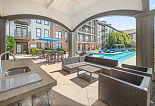 View of swimming pool from covered lounge area at MAA West Village luxury apartments in Smyrna, GA