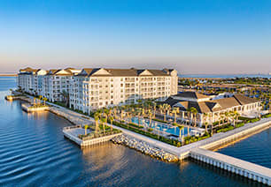 Aerial view of bayside saltwater pool and clubhouse situated at MAA Breakwater luxury apartments in Tampa, FL