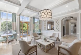 Side view of community clubhouse sitting area with stylish circular hanging light fixture at MAA Shiloh luxury apartments in Kennesaw, GA
