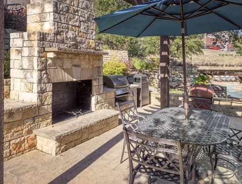 Outdoor grill and fireplace area at Colonial Grand at Valley Ranch luxury apartment homes in Dallas, TX