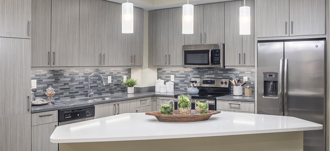 Large kitchen space with granite countertops and stainless steel appliances at MAA Centennial Park luxury apartments in Atlanta, GA