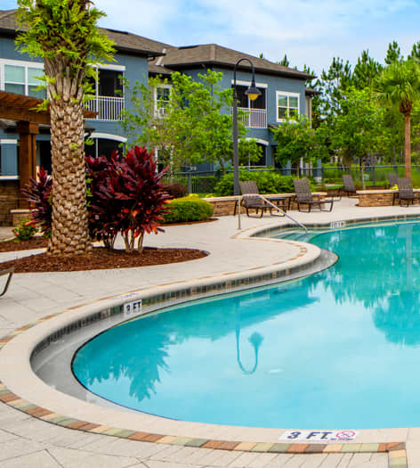 Pool by Pond at MAA Hampton Preserve luxury apartment homes in Tampa, FL