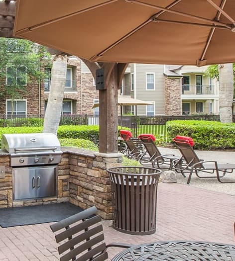 Outdoor grill area at Reserve at Woodwind Lakes luxury apartment homes in Houston, TX