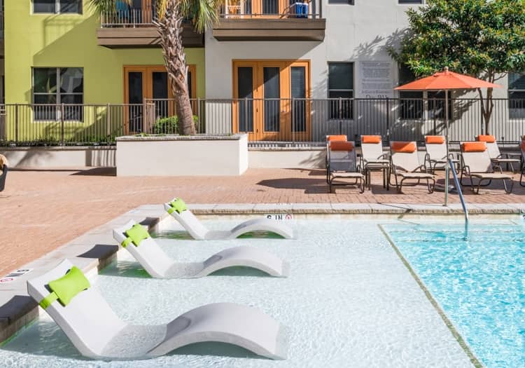 Pool tanning shelf at Post Katy Trail luxury apartment homes in Dallas, TX