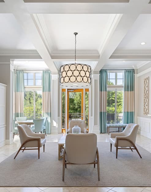Luxurious community clubhouse with tall ceiling picture windows, sitting area and stylish lighting at MAA Shiloh luxury apartments in Kennesaw, GA