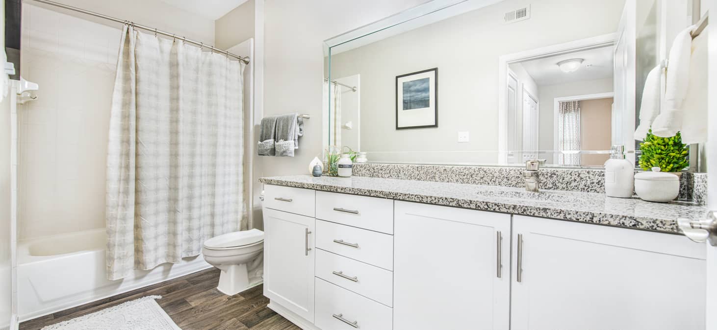 Upscale white bathroom with granite countertops at MAA Riverside luxury apartments in Atlanta, GA