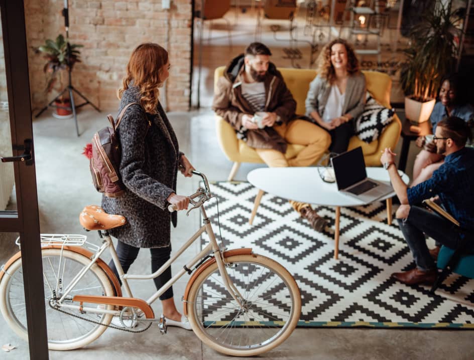 Woman brings her bike into a lobby