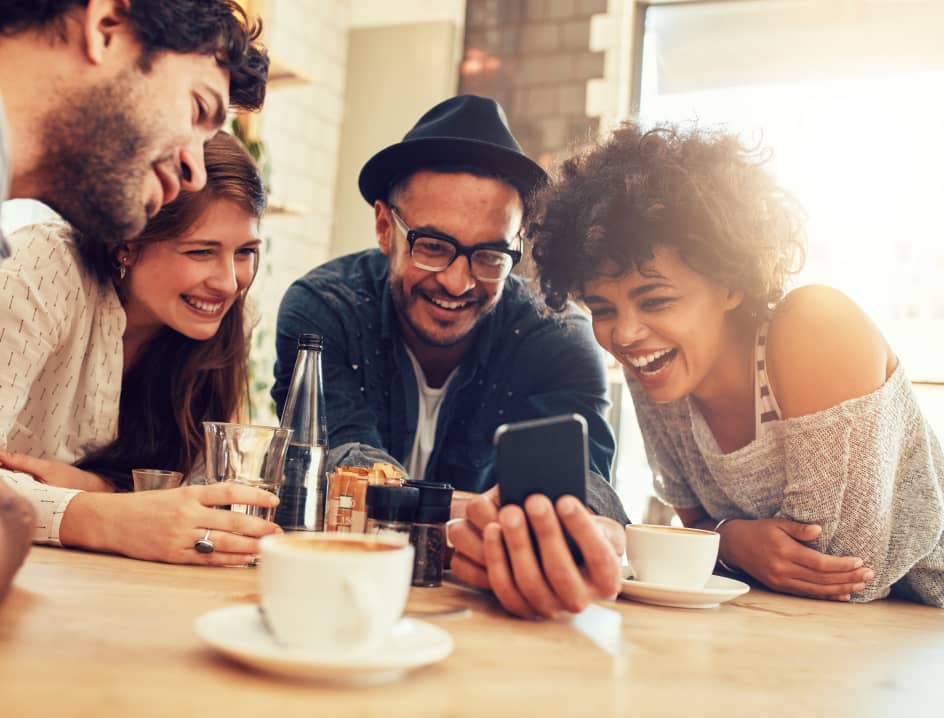 Friends gathered around a table at a cafe