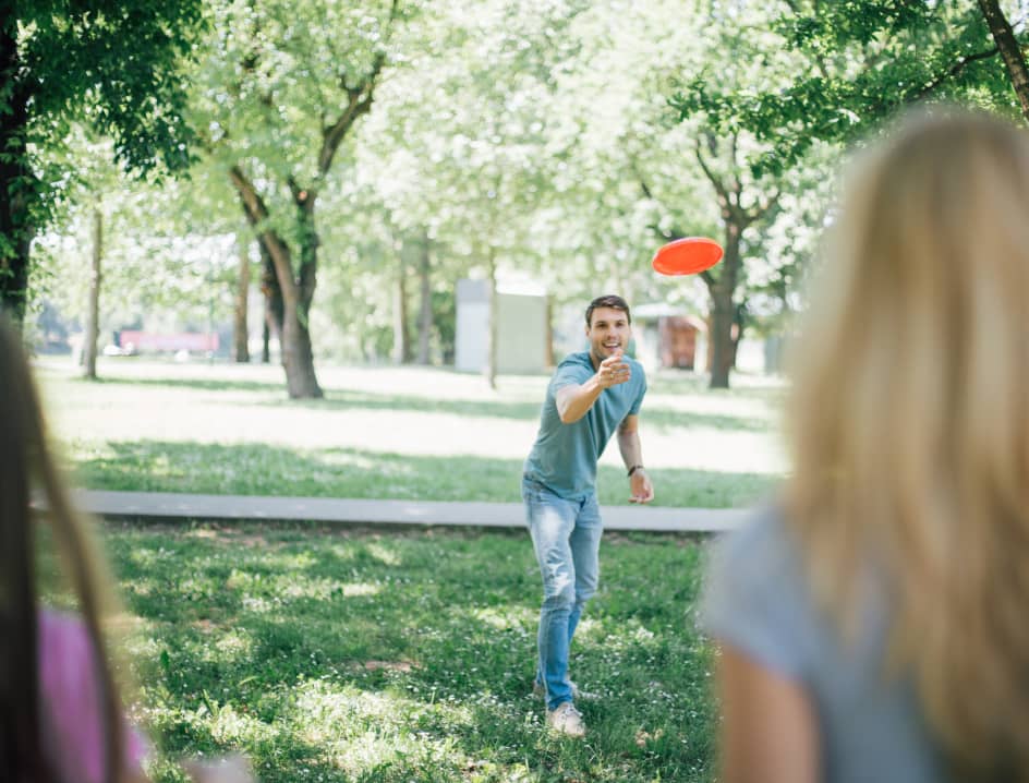 Tossing a frisbee in a park