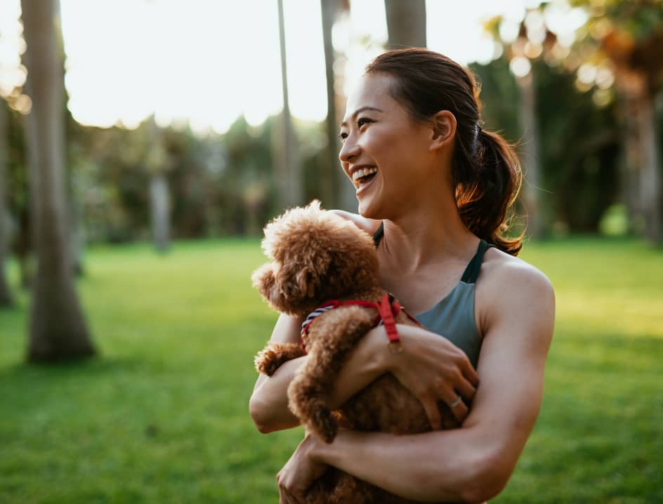 Woman holding puppy outside