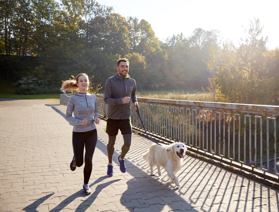 Woman and Man run with dog
