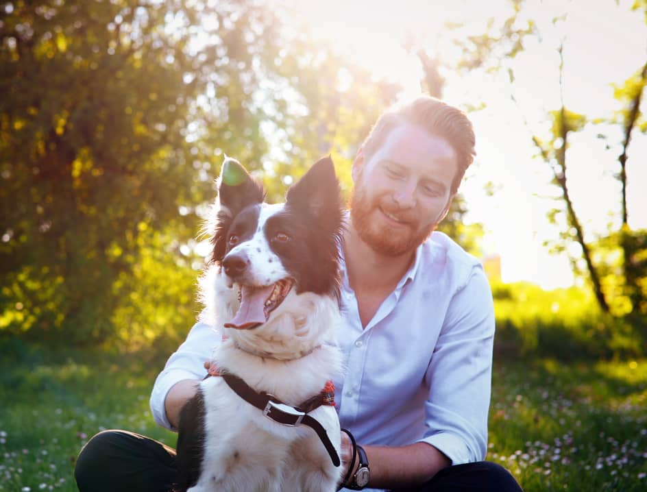 Man pets dog outside