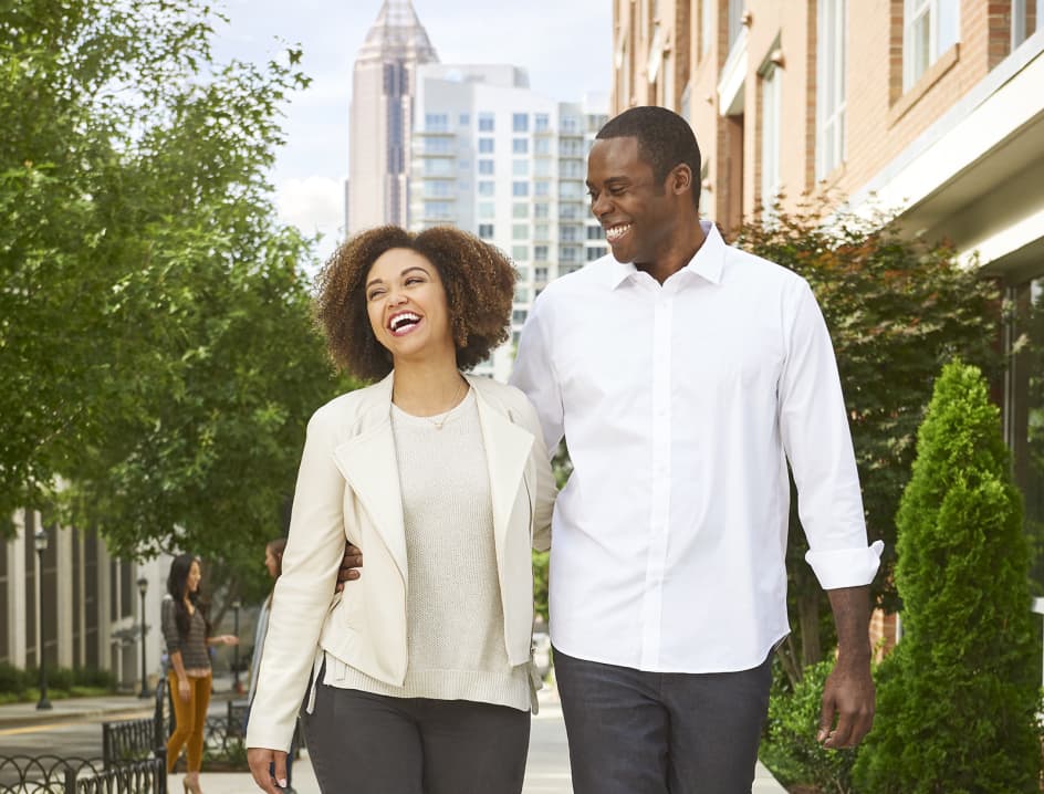 Man and woman walk together smiling