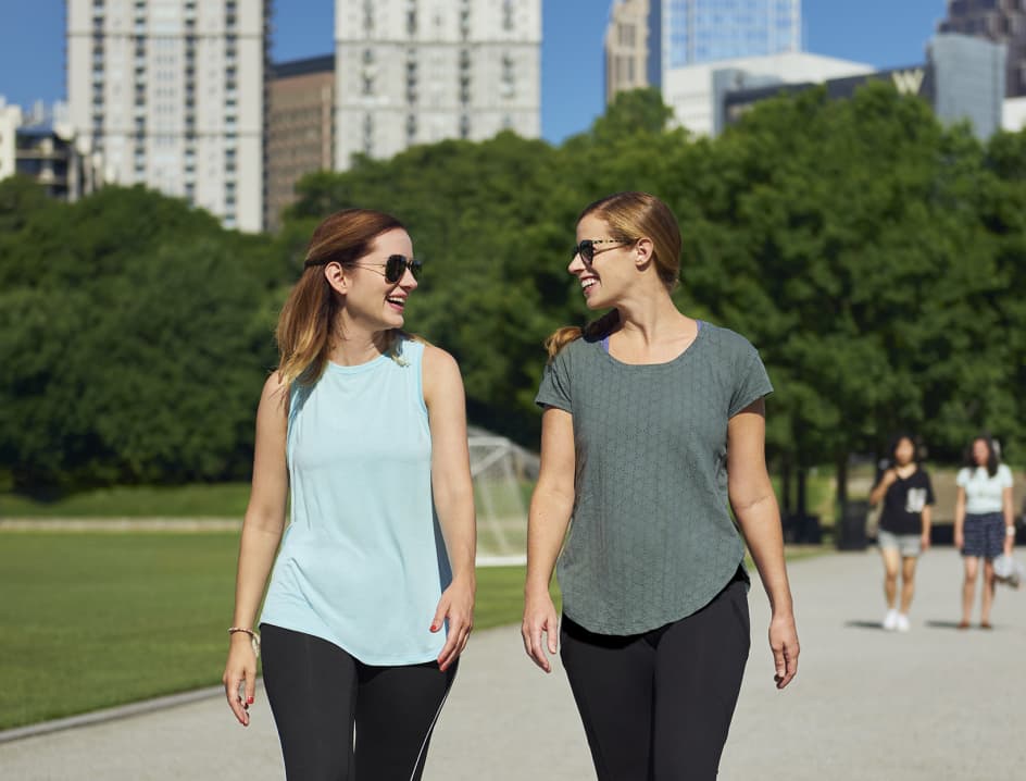 Two women walk outside