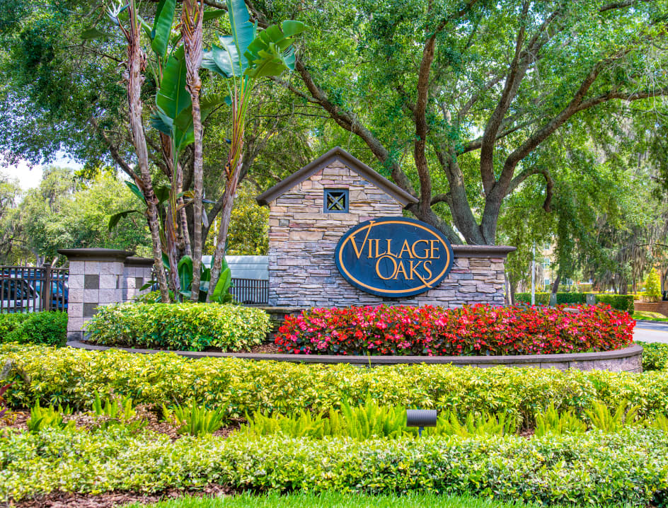 Welcome sign at Village Oaks luxury apartment homes in Tampa, FL
