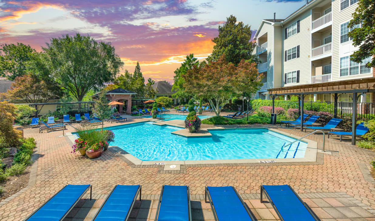 Main swimming pool with lounge chairs and a pergola at MAA Briarcliff luxury apartments in Atlanta, GA