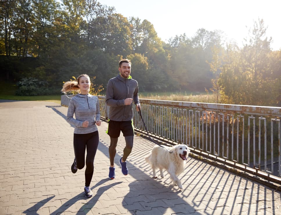 Woman and Man run with dog