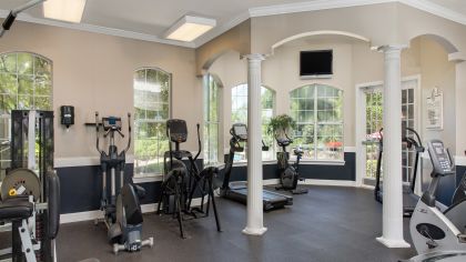 Fitness center with stationary bikes, treadmills and weight machines at MAA Heathrow luxury apartments in Orlando, FL